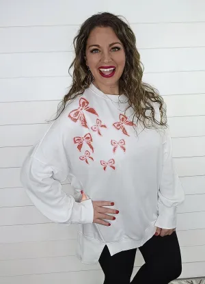 WHITE SEQUIN BOW ACCENT HI LOW PULLOVER