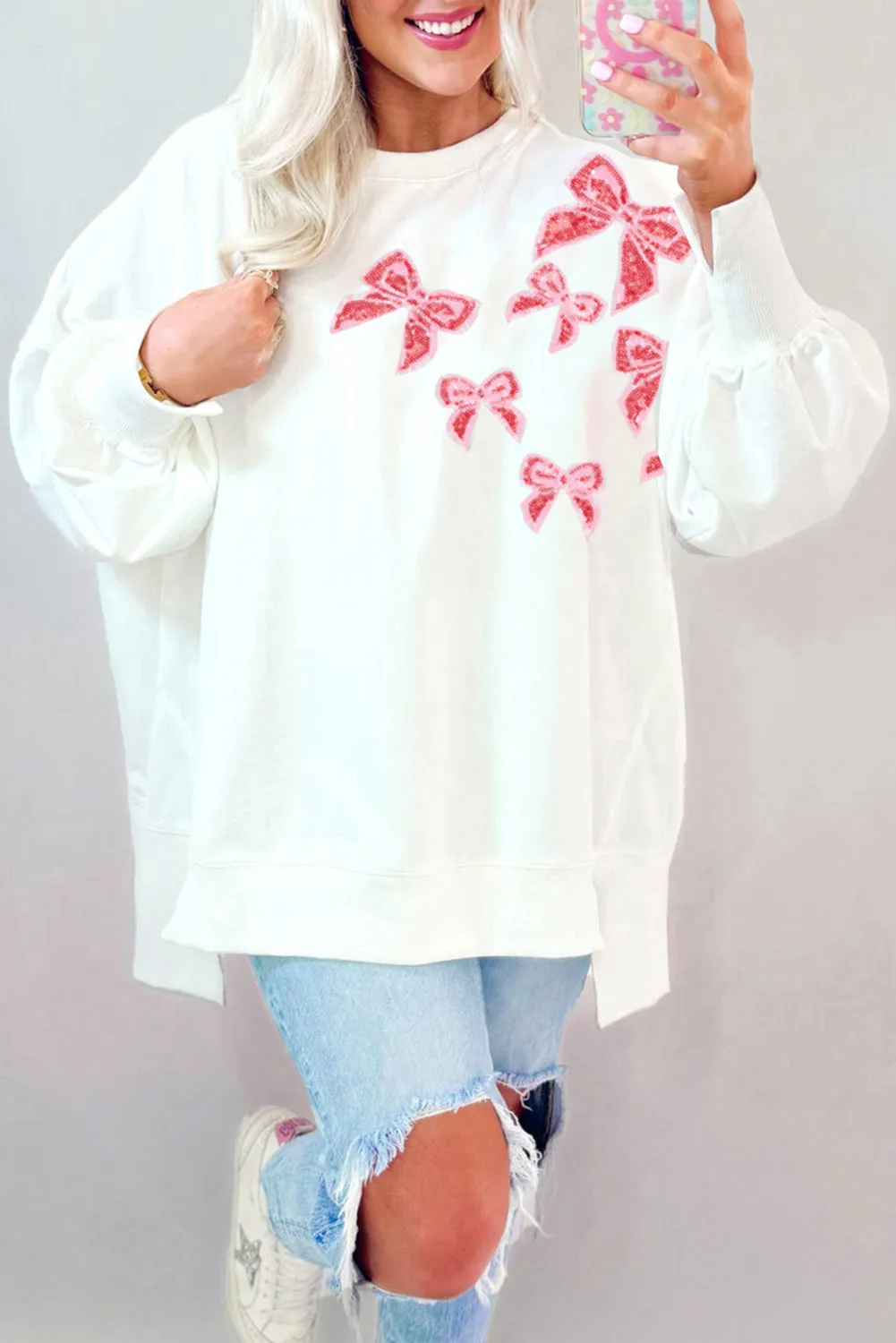 WHITE SEQUIN BOW ACCENT HI LOW PULLOVER